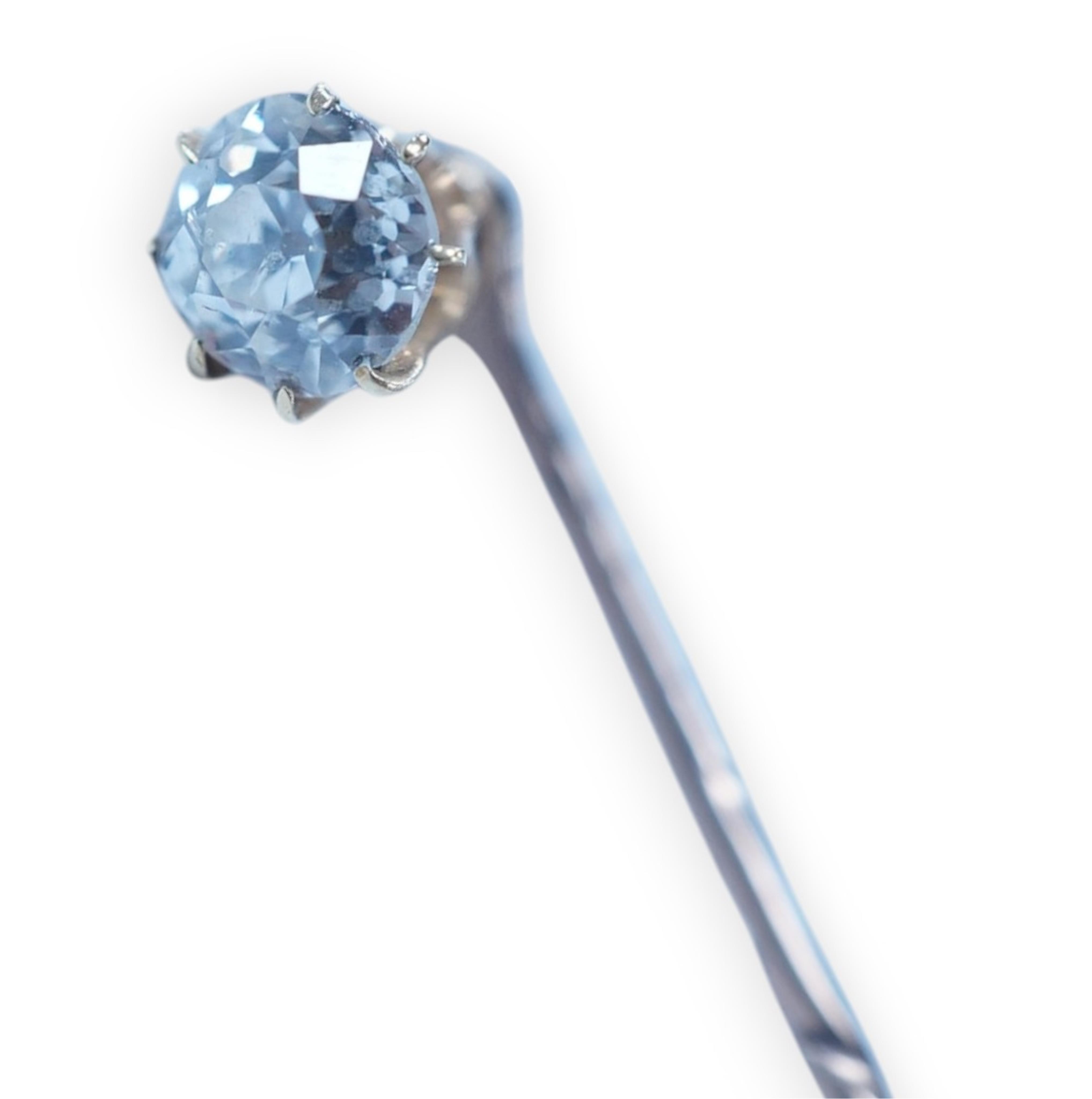 A yellow metal and solitaire diamond set stick pin, the stone diameter approx. 5mm, 59mm, gross weight 2.3 grams. Condition - fair to good